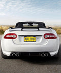 Rear view of a white convertible with Real Carbon Fiber License Plate Frame Hand Wrapped With Stainless Steel Holder Black Car Tag Cover in use.