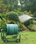 Heavy Duty Garden Hose Reel Cart With Wheels And High Pressure Water Whip For Hassle Free Yard Work in a garden setting.