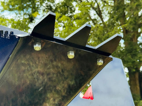 Close-up of Beefy Stump Bucket For Tractors 32 To 60 HP Front End Loader Attachment, showing durable metal teeth and bolts.