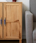 Wooden cabinet with Chinese Style Ceramic Cabinet Pulls Set Of 4 In Antique Bronze With Screws, next to a grey couch