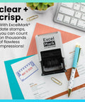 Badass Date Stamp Featuring Custom Text Options And Dual Blue Red Ink With A Legit Gray Mount on desk with documents.