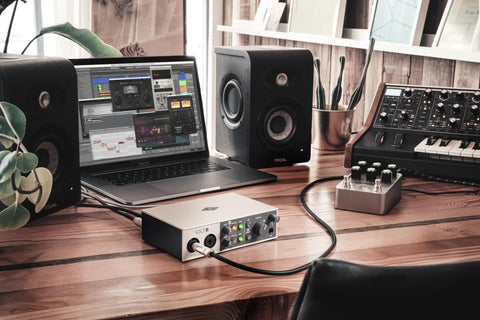 Volt 2 USB Audio Interface with Vintage Preamp Mode and 24-Bit 192 KHz Conversion on a studio desk with speakers and laptop.