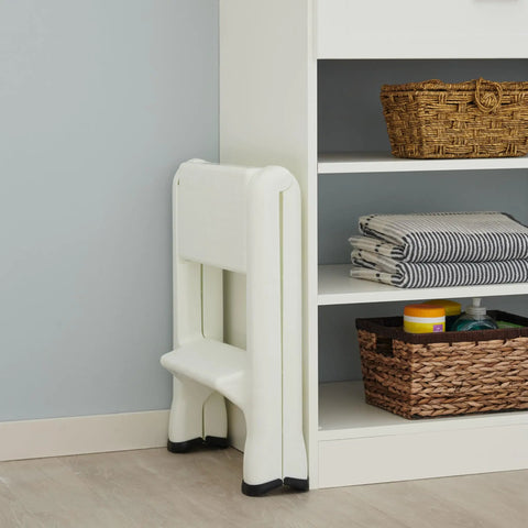 Two Step Folding Foot Stool, 14 Inch High, 300 Pound Capacity, folded near shelf in modern room, lightweight and compact design