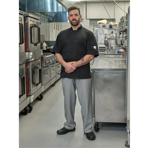 Badass Short Sleeve Chef Jacket In Sharp Black features double breasted front, worn by chef in commercial kitchen.