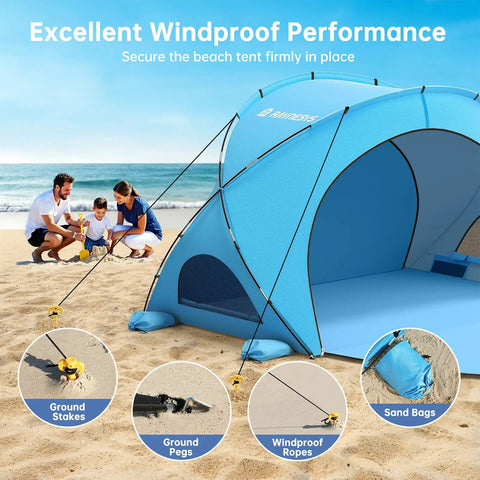 Blue Beach Shade Tent With UPF50 UV Protection pitched on sand with stakes and ropes, family playing nearby, two zippered doors visible.