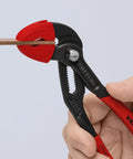 Heavy Duty Protective Jaw Covers For 7 And A Quarter Inch Cobra Pliers in use, red plastic guards gripping metal, close-up view