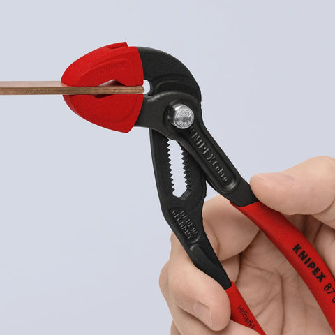 Heavy Duty Protective Jaw Covers For 7 And A Quarter Inch Cobra Pliers in use, red plastic guards gripping metal, close-up view