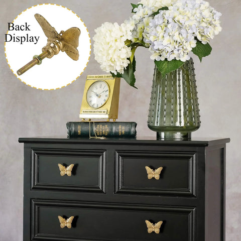 2 Pack Butterfly Cabinet Knobs In Gold Pewter With Delicate Wings And Lifelike Antennae Bringing Whimsical Vibes To Girls Room Dresser Vanity Hardware on black dresser with clock and flowers