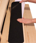 Applying 6 By 30 Inch Non Slip Stair Tape For Outdoor And Indoor Stairs 10 Pack Black Anti Slip Strips on wooden step