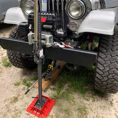 Seven Sparta off-road base stand for Hi-Lift jack with black steel post and red base plate on Jeep front.