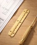 Continuous Hinge Heavy Duty Eight Pack Gold Iron Piano Hinge 3.94 By 0.59 Inch on wooden table with screwdriver