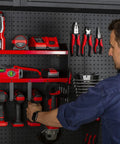 Person organizing tools on Heavy Duty Wall Mounted Power Tool Organizer With Drill Holder, Garage Storage Rack, 2 Shelves, Red.