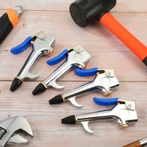 Four Piece Lever Blow Gun Set With Rubber Tip Nozzles And Safety Tips on wooden surface with tools