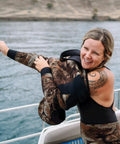 Person using Neo Slix Wetsuit Entry Lubricant 16.9 Fl Oz Water Based Silicone Free Formula That Cuts Friction For Easy Wetsuit Entry And Removal