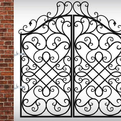 Ornate iron gate with swirling patterns installed on a brick wall, showcasing decorative design and strong metal framework.