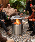 Group enjoying a fire with Beefy Heat Diffuser For 15 Inch Ranger Fire Pit And Portable Stove, 304 stainless steel with detachable legs.