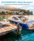 Tough As Nails 48 Inch Dock Piling Bumpers 2 Pack Marine Grade protectors on a wooden dock with a boat moored nearby.