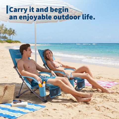 Two Pack Folding Beach Chairs For Adults With Cup Holder, Storage Pocket And Carry Bag on a sandy beach with people relaxing