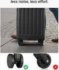 Black hardside luggage on four spinner wheels; front view of suitcase on pavement.