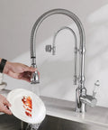 Ialtruistic 2-in-1 High Arc Pull Down Swivel Kitchen Faucet, Chrome, in use for washing a plate, solid brass with chrome finish.