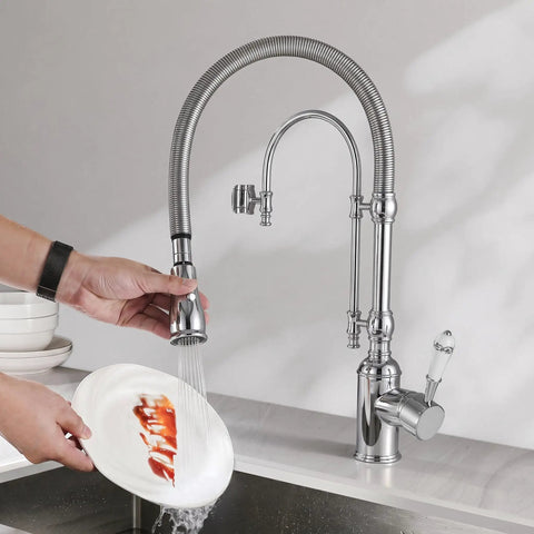 Ialtruistic 2-in-1 High Arc Pull Down Swivel Kitchen Faucet, Chrome, in use for washing a plate, solid brass with chrome finish.