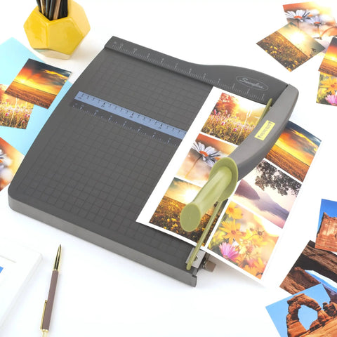 ClassicCut Lite 12 Inch Guillotine Paper Cutter with 10 Sheet Capacity trimming photo prints on a sturdy plastic base.
