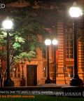 LED-lit outdoor walkway at night with tall lamps illuminating surrounding area and building