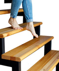 Person walking on clear non slip stair treads for wooden steps indoor with roller 15 pcs pre cut peel and stick anti slip strips for stair runners kid safe and pet friendly easy install durable PEVA material