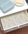 Geometric Hexagon Peel And Stick Wallpaper Removable Self Adhesive Vinyl Film For Walls And Shelves And Drawers And Furniture 17.71 Inch By 118 Inch Roll Easy To Apply No Mess Home Makeovers lining a drawer with a soap and towel.