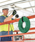 Worker using Reel X Stainless Steel Fishtape 240 Foot One Eighth Inch Wide for smooth cable pulling in industrial setting