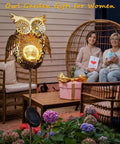 Solar Owl Garden Stake Lights For Lawn And Pathway, bronze crackled glass yard art, illuminating a cozy outdoor seating area.
