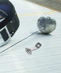 Fencing Foil Display Wall Hanger And Metal Vertical Storage Mount on floor with fencing helmet and foil blade nearby