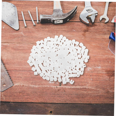 White plastic hinge dowels, 200 pcs, high-load, for stable doors and bathroom furniture, on wood workbench.