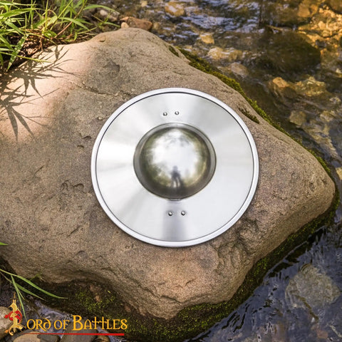 Old School Medieval Steel Buckler Shield Handcrafted With Wooden Grip on rock by stream, 30 cm, 16-gauge, polished finish