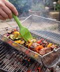 2 In 1 Rolling Grill Basket With Rotating Stand And Hooks Heavy Duty Stainless Steel Rotatable BBQ Mesh Cylinder in use on grill