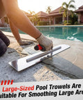 Heavy Duty Pool Trowel With Rounded Front And Square Back Edge For Fine Finish 20 By 4 Inches Stainless Steel Masonry Plastering Drywall Construction Hand Tool With Soft Grip being used to smooth concrete next to a pool.