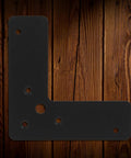 Tough As Nails 4 Piece Black L Shaped Stainless Steel Corner Bracket 2mm Thick Flat Angle Brace on wood backdrop