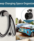 Heavy Duty J1772 EV Charger Holder Wall Mount Electric Vehicle Cable Organizer with SAE J1772 Plug in use beside parked car.