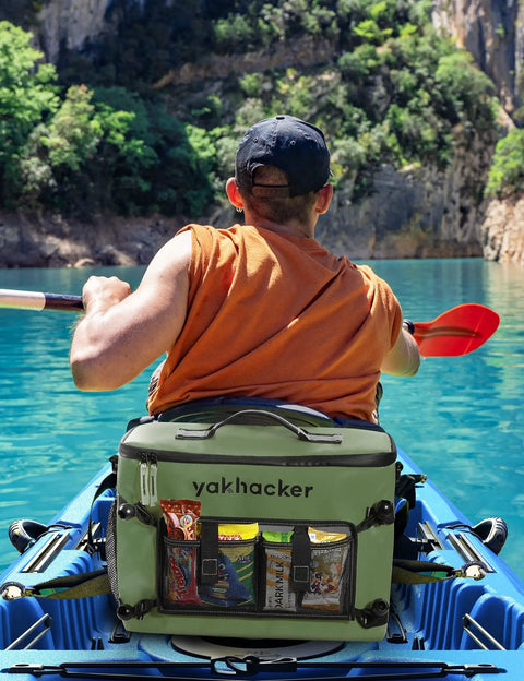 Kayaker with waterproof kayak cooler bag with seat back design on a sunny day in clear blue water