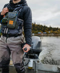 Angler wearing Stormshadow Fly Fishing Chest Pack With Waterproof Pocket, Self Healing Zipper, Velcro Fly Patch on a boat