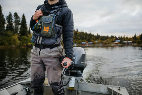 Angler wearing Stormshadow Fly Fishing Chest Pack With Waterproof Pocket, Self Healing Zipper, Velcro Fly Patch on a boat