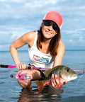 Woman holding fish with Telescopic Fishing Rod And Reel Combo For Ladies Pink Spinning Pole Set For Beginners Women Includes Line And Essential Accessories