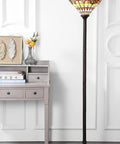 70 Inch Bronze Tiffany Style Stained Glass Torchiere Floor Lamp With Handcrafted Iron Stand next to a light grey desk