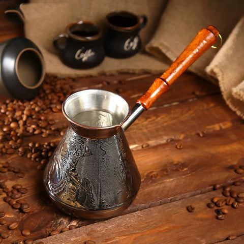 Engraved Copper Turkish Greek Arabic Coffee Pot For Stovetop Brewing Cezve Ibrik Briki 25 Oz With Wooden Handle shown on a table