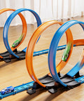 Epic Car Race Track Set for Kids Ages 3 To 12 With 45 Track Pieces And 4 Small Cars Dual Loop Tracks For Competitive Racing Perfect Gift For Boys And Girls showing blue and orange loops with small cars on a wooden floor
