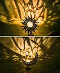 Two Pack Sun Moon Solar Garden Lights Outdoor Waterproof Metal Decorative Lamps casting warm patterns on a wall.