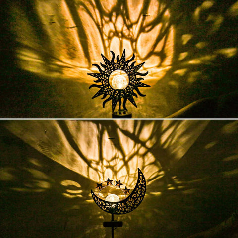 Two Pack Sun Moon Solar Garden Lights Outdoor Waterproof Metal Decorative Lamps casting warm patterns on a wall.