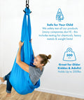 Person sitting in blue sensory swing for kids and adults that feels like a big hug, indoor and outdoor safe, holds up to 300lbs