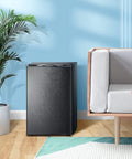 Slick Compact 3 Cubic Feet Upright Freezer In Matte Black Housing With Two Slide Out Shelves in a modern living space.