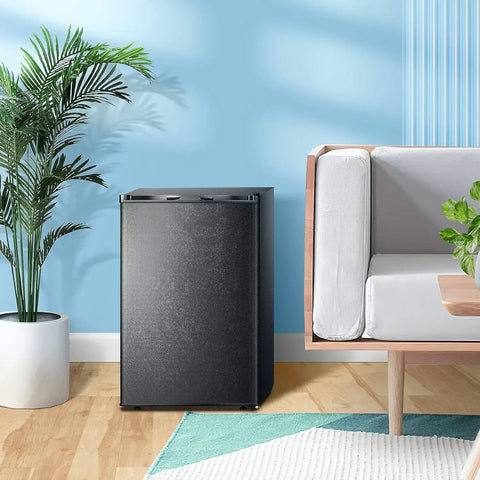 Slick Compact 3 Cubic Feet Upright Freezer In Matte Black Housing With Two Slide Out Shelves in a modern living space.
